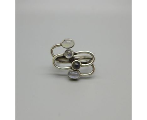 A white metal Arts and Crafts design moonstone set ring, tests as silver, R 