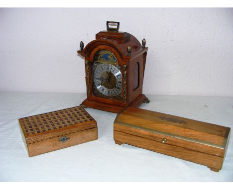 A modern Franz Hermle mantle clock standing on four scroll feet measuring 12" tall along with two wooden boxes. CONDITION REP