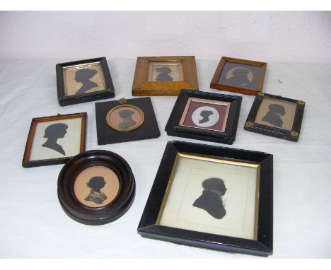 Nine framed portrait silhouettes in ebonised and parquetry wooden frames, some Victorian examples and later, the largest at 7