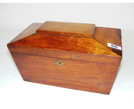 A 19th century mahogany sarcophagus shaped tea caddy with a fitted interior including original glass mixing bowl and with its