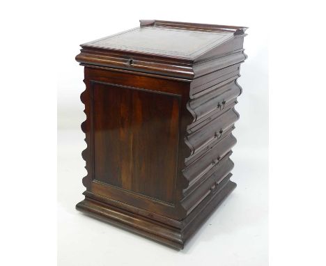 A circa 1830 rosewood slide-top davenport of unusual outline, having a gilt-tooled leather inset hinged writing surface above