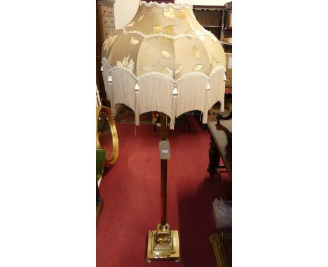 A gilt brass Corinthain column standard lamp, with silk shade, together with a brass fender (2)