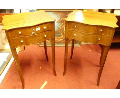 A pair of Edwardian mahogany and boxwood strung serpentine shaped two-drawer bedside tables, raised on moulded slender slight