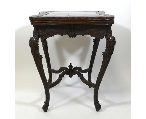 An early 20th century Chinese carved hardwood card table, of wasted square section, with removable cover opening to reveal ba