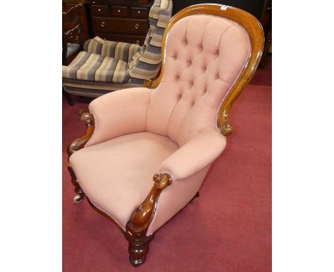 A mid-Victorian mahogany showframe nursing chair, pink fabric button back upholstered and raised on turned forelegs to castor