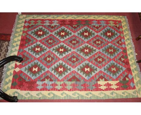 A Turkish woollen bright coloured tribal Kelim rug, 173 x 127cm; together with a Turkish Kelim hall rug (2)