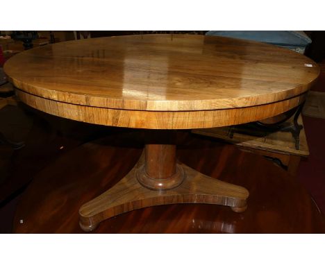A William IV rosewood circular tilt-top pedestal breakfast table, raised on plain gun barrel support to triform base, dia. 11