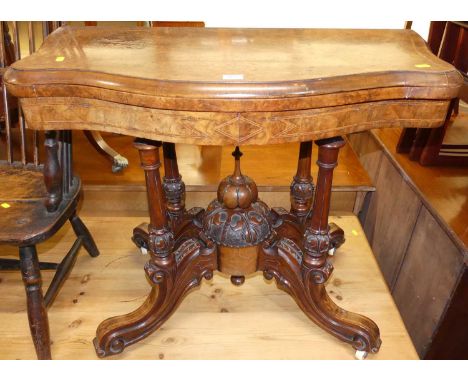 A mid-Victorian figured walnut and satinwood cross banded serpentine front fold-over baize lined card table, having a swivel 