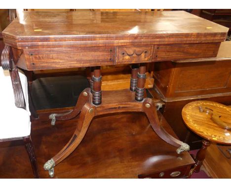 A Regency mahogany and rosewood cross banded foldover baize lined card table, having swivel top, raised on ring turned column