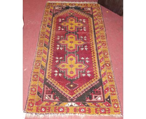 A Turkish woollen red and mustard ground Kelim rug, 190 x 100cm 