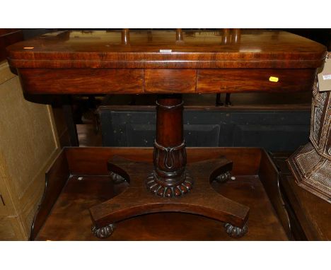 An early Victorian rosewood D-end baize lined fold-over card table, having a swivel top raised on gun barrel and floral decor