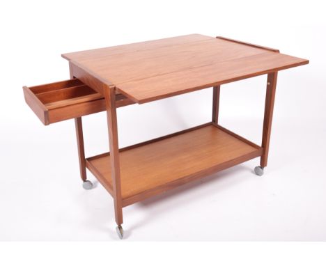 Vintage / Retro : A 'Remploy' teak push-pull tea trolley. On castors, with drawer to one end and drop flap sides, H65cm x W84