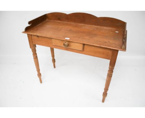 A vintage pine washstand. With single central drawer on turned tapering supports, L99cm x D44.5cm x H85cm