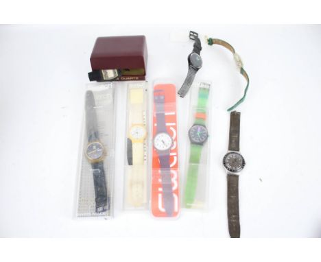 Seven assorted Swatch Quartz wristwatches and a Timex. Four in original Swatch boxes, Timex Quartz 'Marathon' in box.