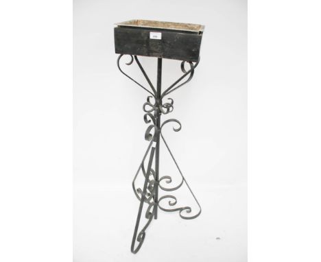 A vintage wrought iron plant stand. Tripod support with scroll work decoration and rectangular top, painted black, H117cm