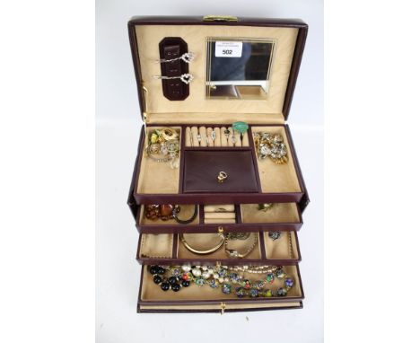 A collection of vintage costume jewellery in a lockable leather jewellery box