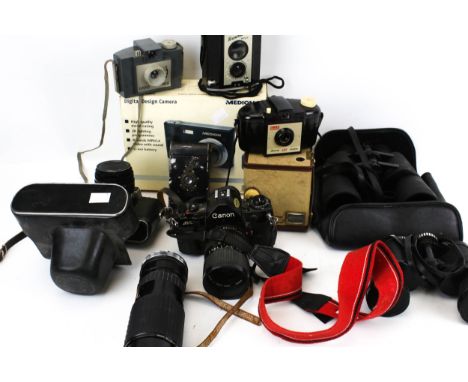 A collection of assorted vintage cameras and binoculars. Including a Canon A-1 with 35-70mm zoom lens, Minolta 21x50 binocula