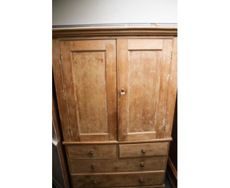 A substantial one piece vintage stripped pine cupboard. With a three drawer base, of two short over two long drawers and two 