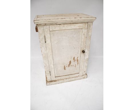 A vintage white painted pine cupboard. With a single door and two shelves, L66cm x D40.5cm x H92cm