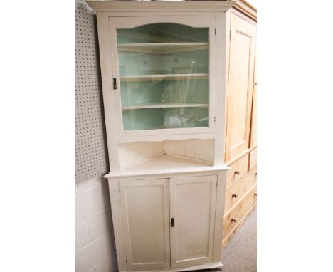 A vintage white painted corner display cupboard. Upper glazed section, open shelf and two door cupboard, L97cm x D68cm x H220