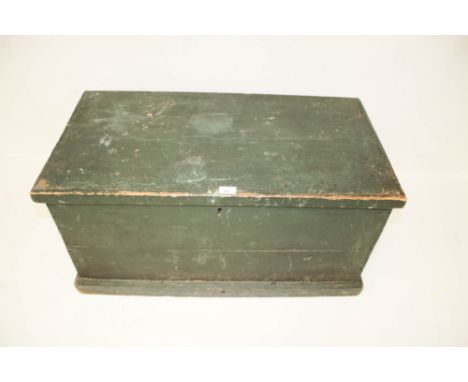 A Victorian pine trunk. Painted green, with handles either side and on a plinth base, the interior covered with patterned pap