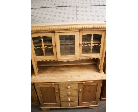 A vintage continental style pine dresser. With glazed top, central section of leaded glass and flanked by doors. Below a pull