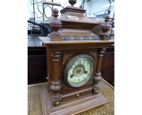 A VICTORIAN WALNUT CASED MANTLE CLOCK AND A BAMBOO SMALL TABLE. 