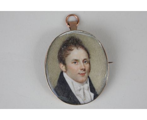An oval portrait miniature of a gentleman wearing a black coat, 5cm by 4cm, in glazed gilt frame