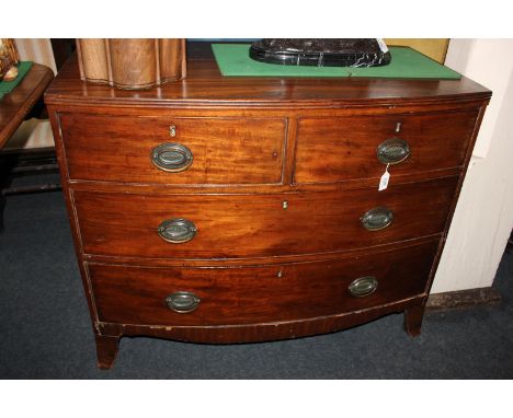 A George III mahogany bow-front chest of two short over two long drawers with oval brass drop handles, on splayed bracket fee