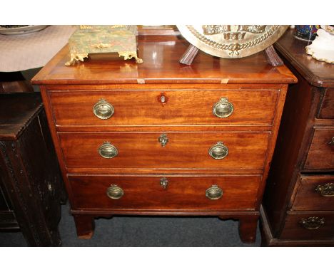 A small cross-banded mahogany chest of three drawers, on bracket feet, 77cm