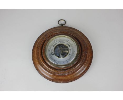 An oak cased aneroid wall barometer, 19.5cm diameter 