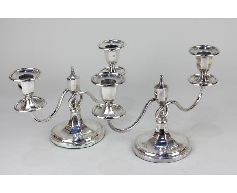 A pair of George V silver two-light candelabra with central finial, two scroll branches, on loaded circular bases, maker Elki