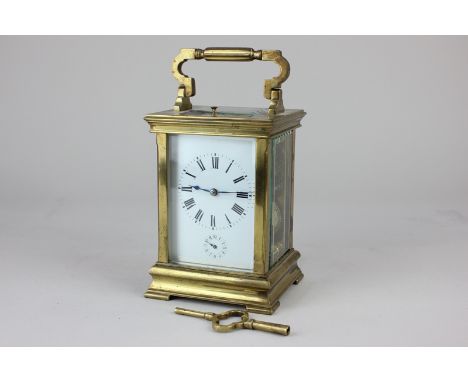 A brass and bevelled glass cased repeater carriage clock, the white enamel dial with Roman numerals and subsidiary seconds di