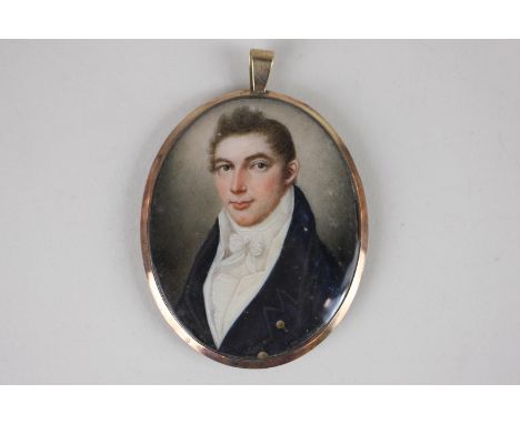An early 19th century oval portrait miniature of a gentleman wearing a blue coat and white cravat, 6.5cm by 5cm, in glazed gi