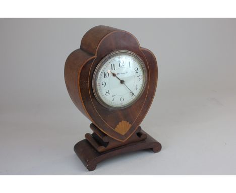 An Edwardian inlaid mahogany heart shaped mantel clock with movement stamped R &amp; Co made in Paris, the circular dial with