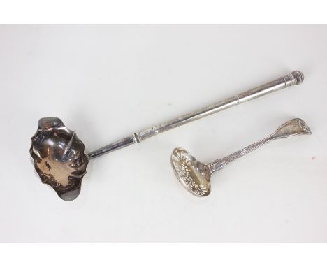 A George III silver brandy ladle, oval double spouted bowl with engraved initials, and a Victorian silver sifter spoon with e