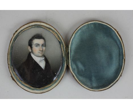 A 19th century oval portrait miniature of a gentleman wearing a black coat and white cravat, 7cm by 6cm, in fitted leather ca