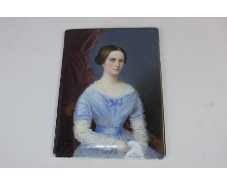 A 19th century portrait on porcelain of a seated young lady wearing blue dress, unframed, 19.5cm by 14cm