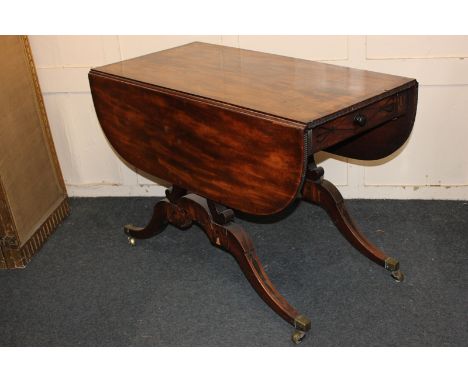 A Regency mahogany drop leaf or Pembroke table, inlaid with ebonised floral and foliate decoration, the drop leaf top with mo