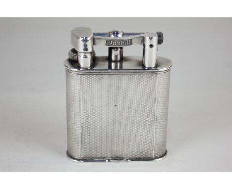 A Dunhill silver plated table lighter, No 737418, with engine turned decoration, 10.2cm high