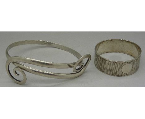 A silver bangle and napkin ring