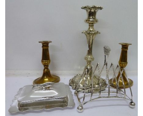 A pair of brass candlesticks, plated ware including a toast rack, sardine dish and a candlestick