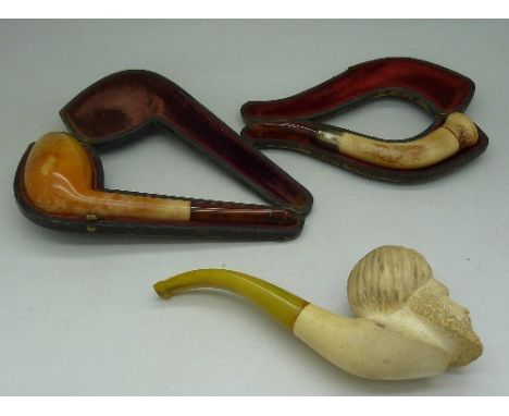 A pipe with silver mount hallmarked Birmingham 1900, cased, one other cased pipe and a carved pipe