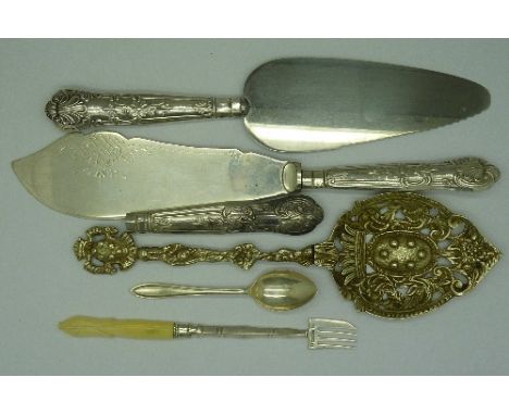 Silver items including a spoon, fork, three silver handles and a white metal server