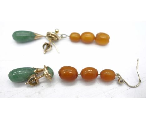 A pair of yellow metal and jade drop earrings with screw backs and a pair of amber coloured drop earrings, one bead a/f