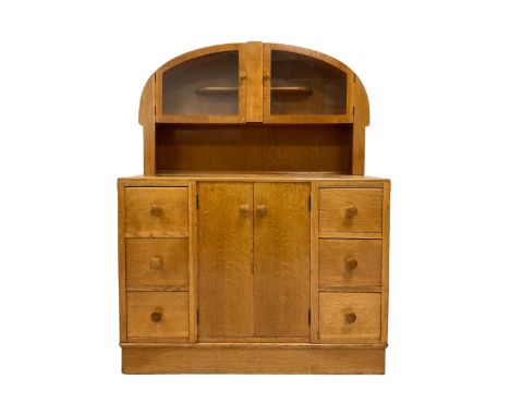 E Gomme - Vintage light oak dresser, the arch top with two glazed doors opening to reveal one fixed shelf over two cupboard d