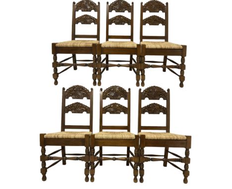 Set six Yorkshire style dining chairs, with carved cresting and back rail over rush seat, raised on turned bobbin supports 