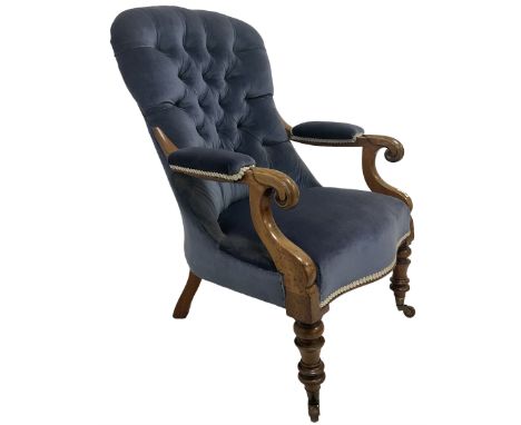 Victorian armchair, upholstered in blue buttoned back fabric, raised on turned supports, terminating in ceramic castors 