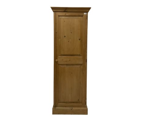 Waxed pine cupboard, fitted with single door, opening to reveal one fixed shelf over one hanging rail, raised on a plinth bas