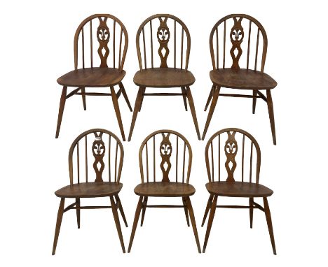 Ercol - set six dining chairs, the spindle and splat back over elm seat, raised on turned supports, united by stretcher 